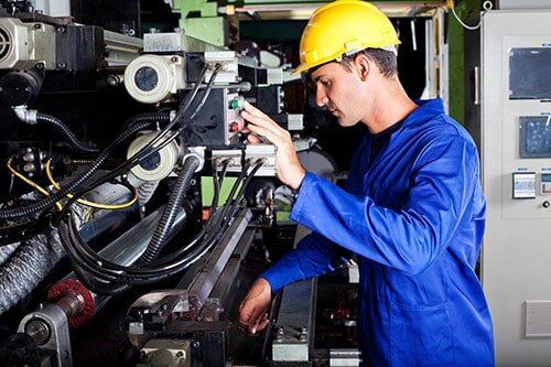 A photo of a worker using a print machine